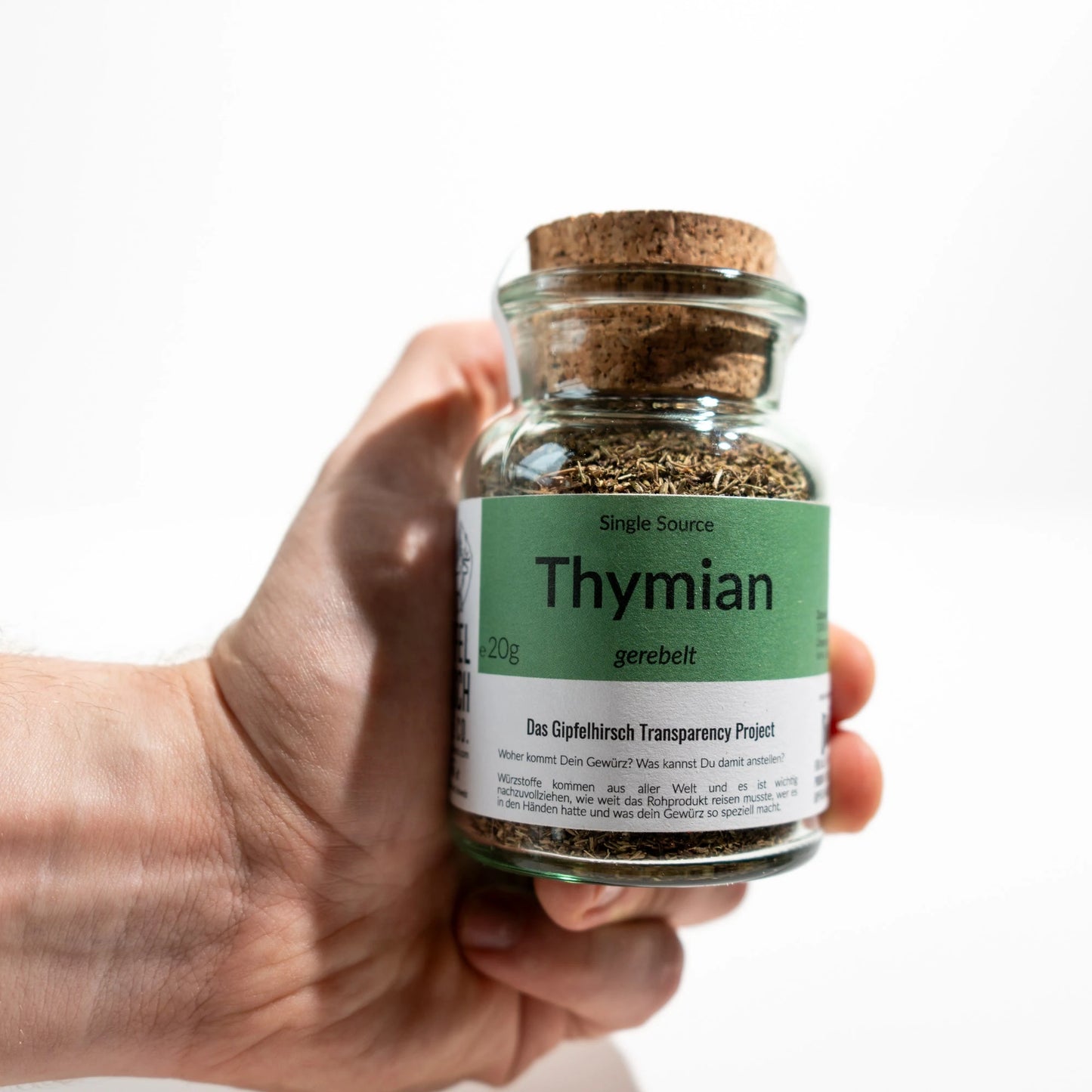 Thyme from Gipfelhirsch held in a hand on white background