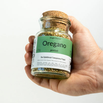 Oregano Herb from Gipfelhirsch held in a hand on white background