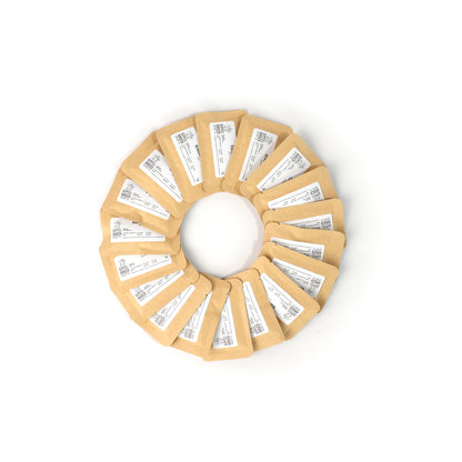 Circular arrangement of 18 small packets with labels on a white background